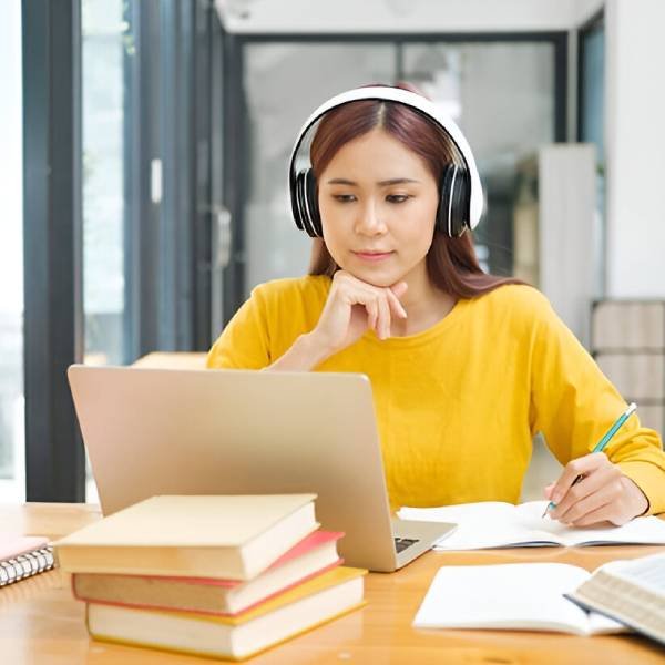 Young collage student using computer and mobile device studying online(1)